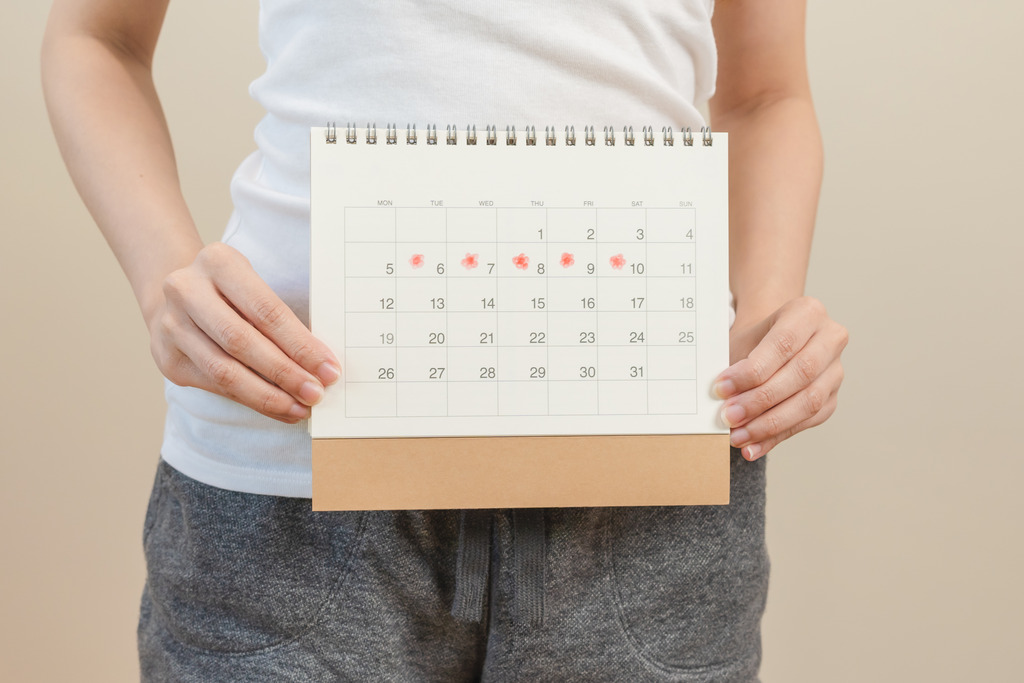 Woman Holds a Calendar and Wonders Why Is My Period Late