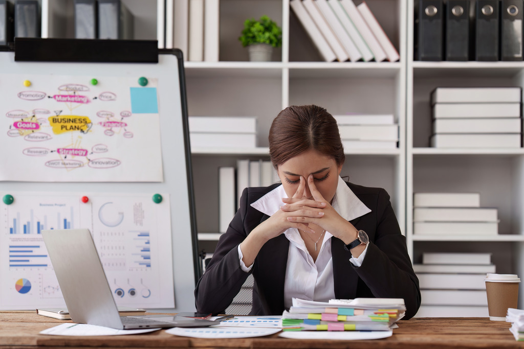 An Overwhelmed Businesswoman Demonstrates Connections Between Stress and Gynecological Problems