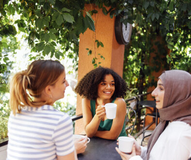 A Group Of Girls Sitting At A Table Drinking Coffee & Talking About Sonohysterogram.