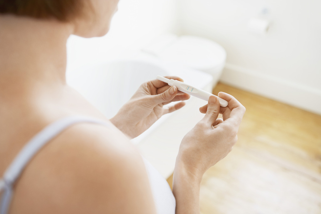 Closeup of a Woman Holding a Pregnancy Test Can You Get Pregnant With Endometriosis