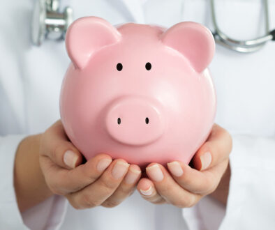 Closeup of a Female Women’s Health Doctor Holding a Piggy Bank In-Office Procedures