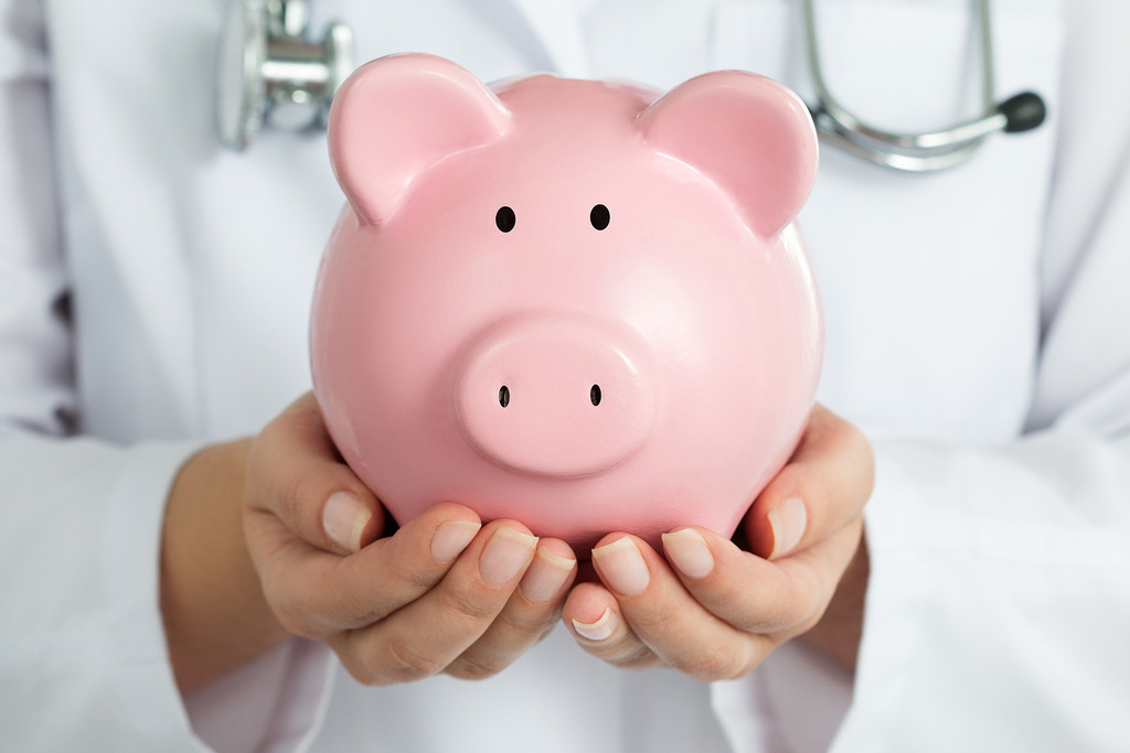 Closeup of a Female Women’s Health Doctor Holding a Piggy Bank In-Office Procedures
