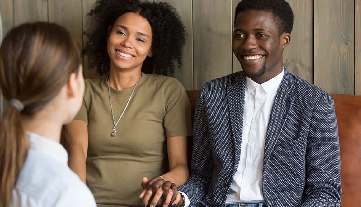 An African American Couple Holding Hands Sitting With A Fertility Specialist Female Fertility Testing